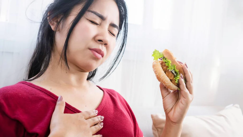 Woman dealing with bad heartburn.