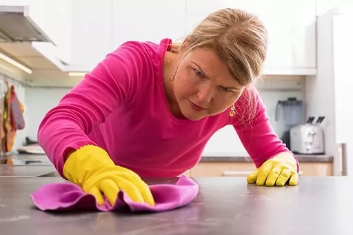 Woman with OCD obsessively cleaning.
