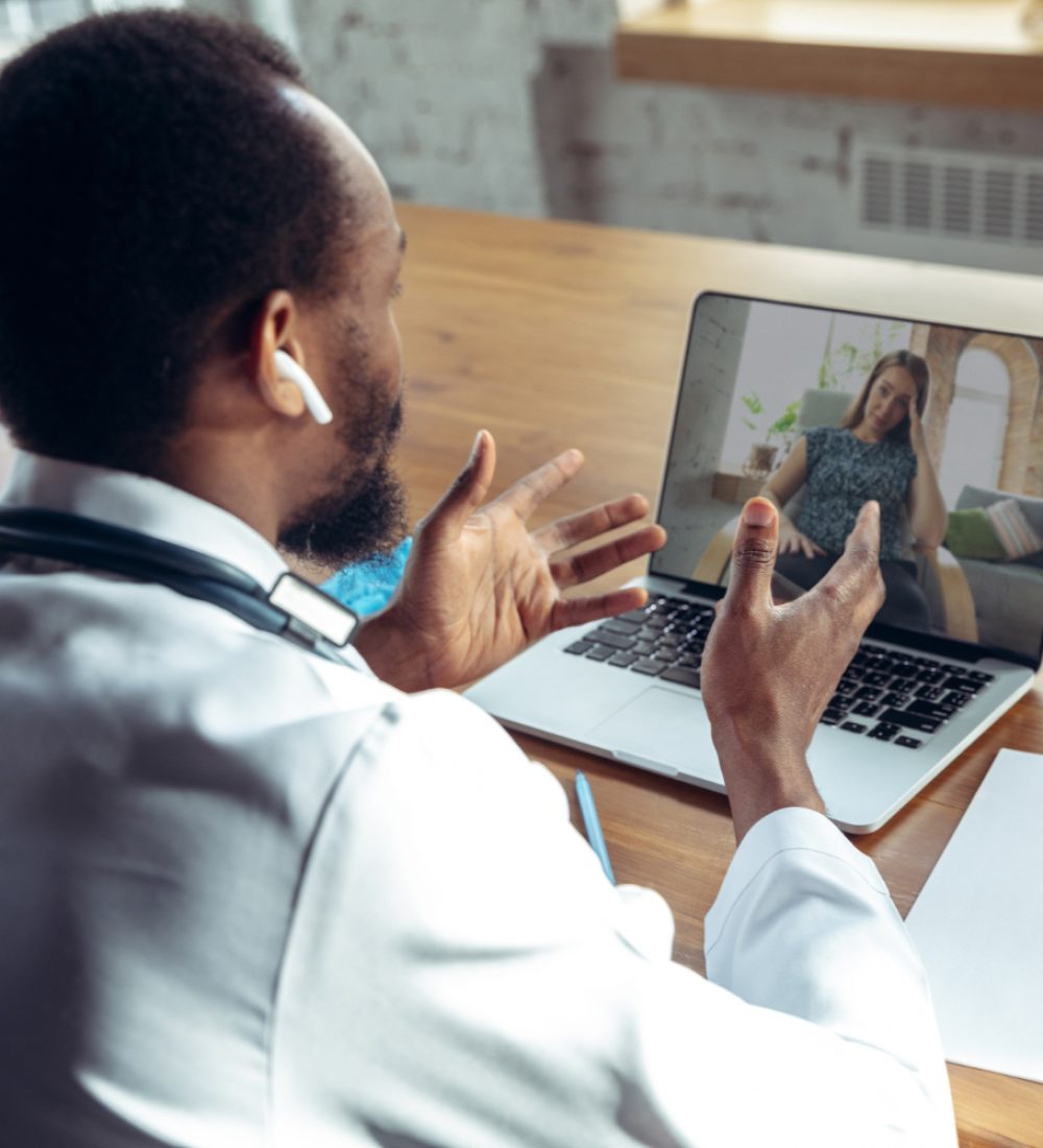 doctor-advising-patient-online-with-laptop